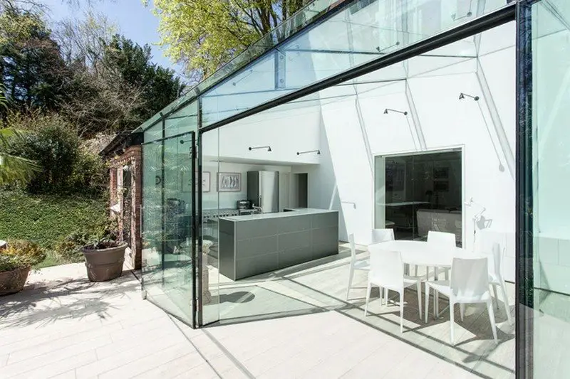 A glass extension rejuvenates a traditional brick home in Hampshire UK
