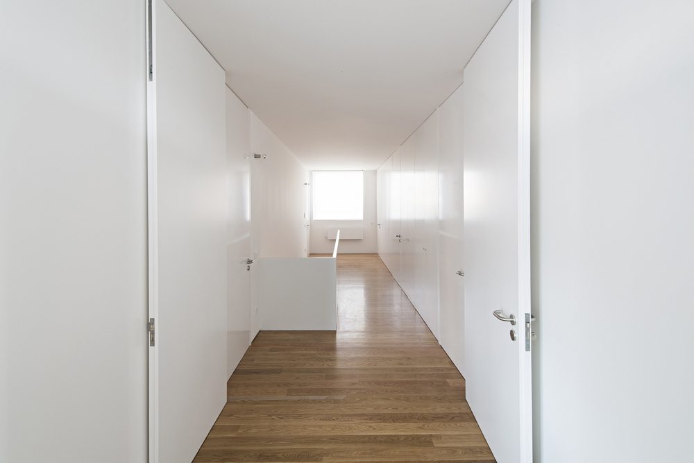 Timber flooring provide a great contrast with stark, almost sterile, white walls.